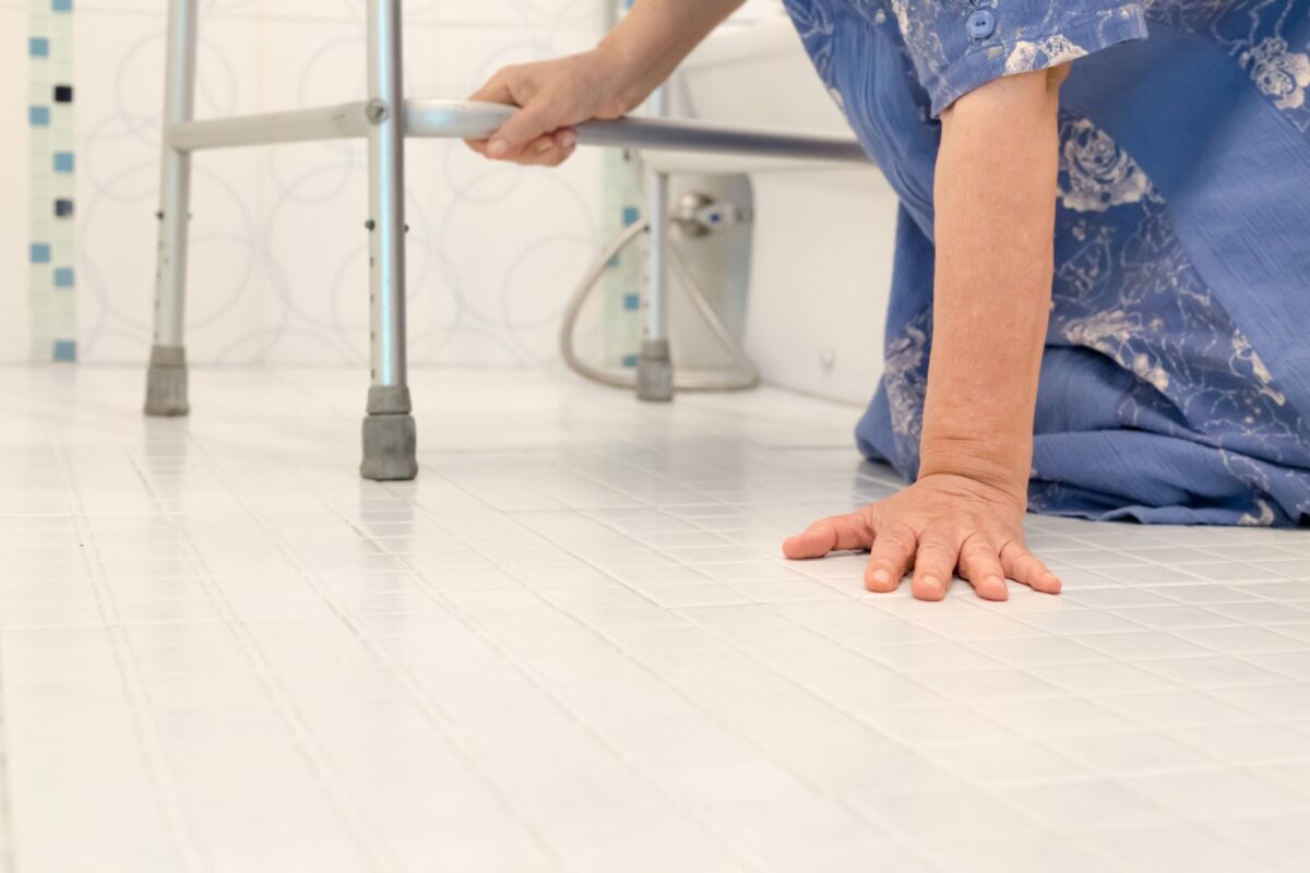 Elderly woman on bathroom floor after falling